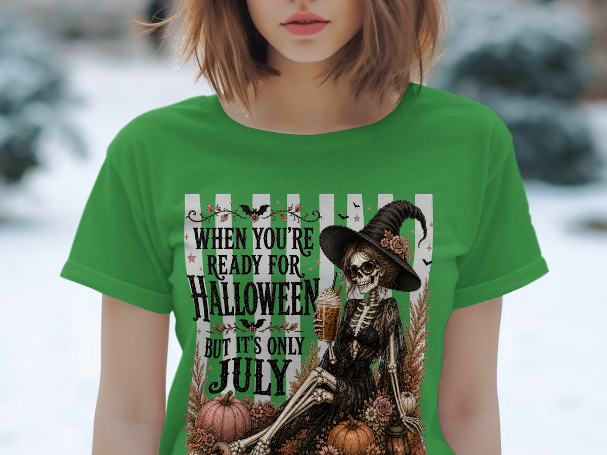 Skeleton witch with drink on shirt that reads "When You're Ready for Halloween But It's Only July."