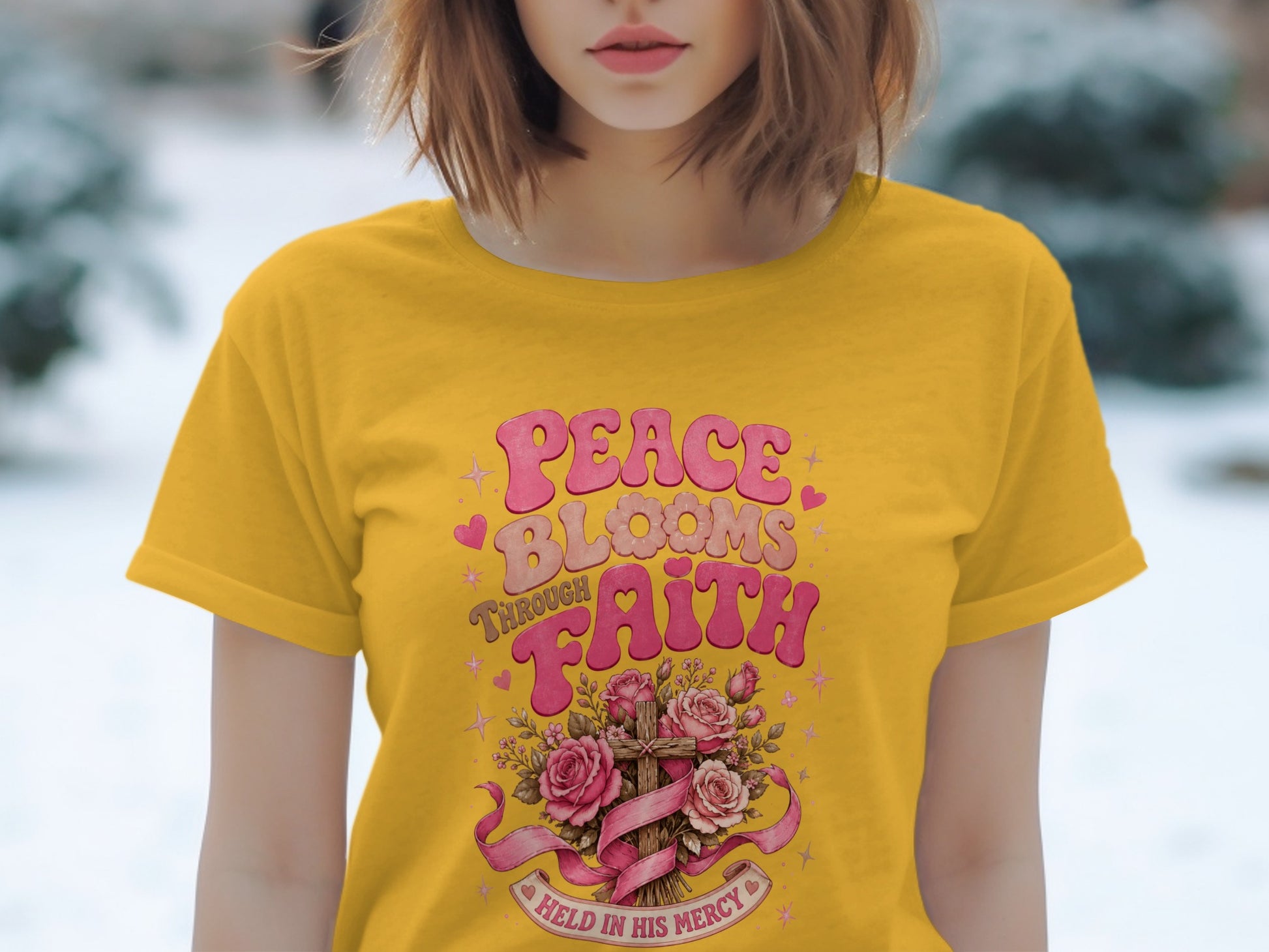 Yellow t-shirt with "Peace Blooms Through Faith" text and floral cross design.