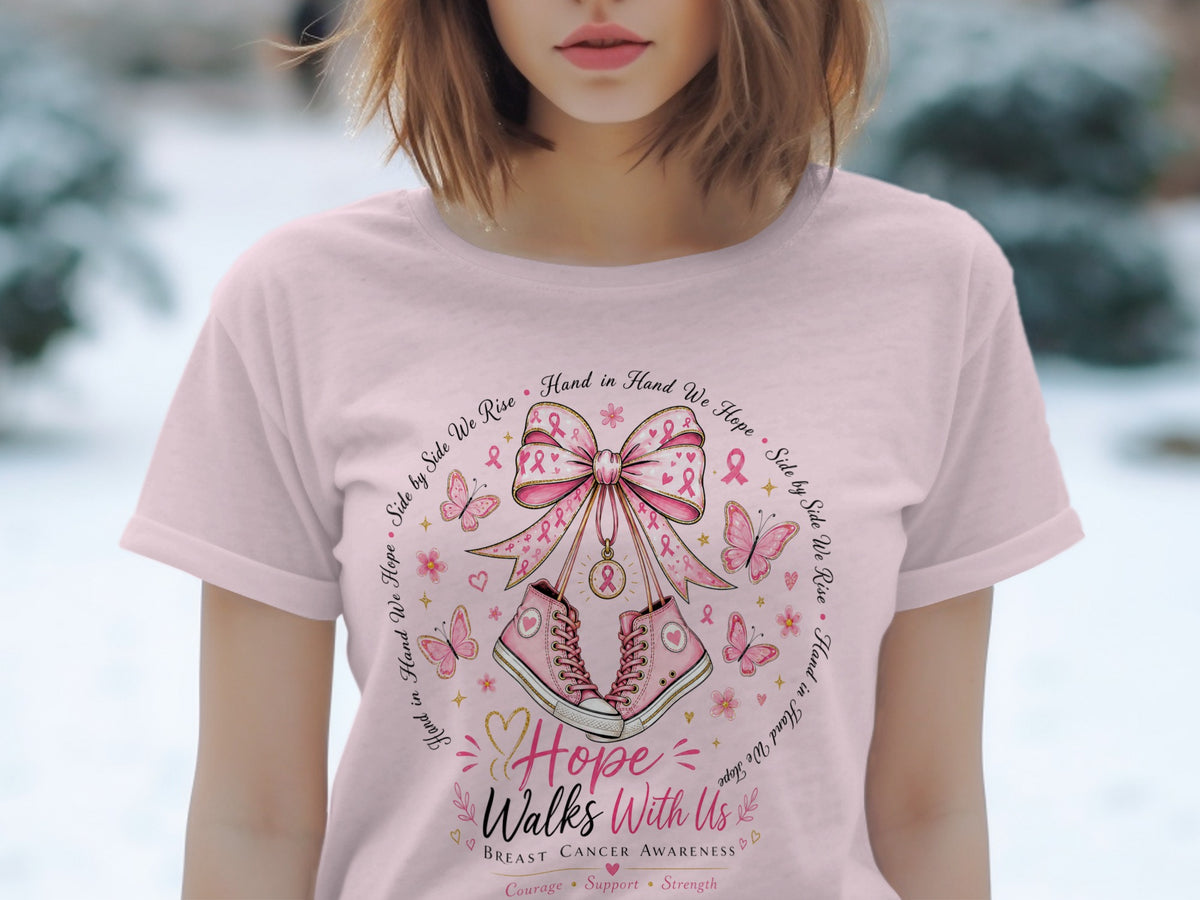 Pink t-shirt with breast cancer awareness design featuring sneakers, butterflies, and ribbons.