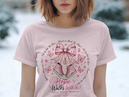 Pink t-shirt with breast cancer awareness design featuring sneakers, butterflies, and ribbons.