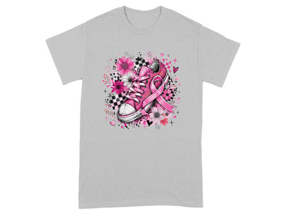 Pink sneaker with a breast cancer ribbon and floral accents on a gray t-shirt.