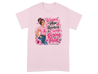 Pink t-shirt with illustration of woman and text "Wrapped in Hope Rooted in Courage Rising in Pink".