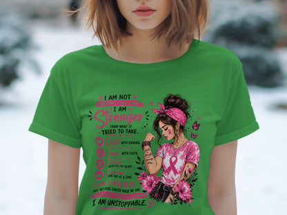 Green t-shirt with graphic of woman and text "I AM Stronger Than What It Tried To Take. I Am Unstoppable."
