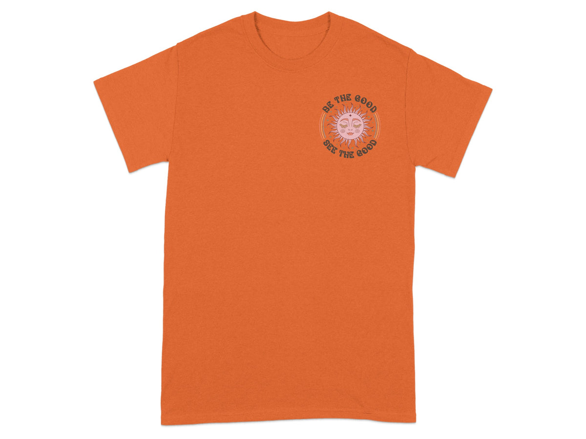 Orange t-shirt with a sun graphic and text "BE THE GOOD SEE THE GOOD".