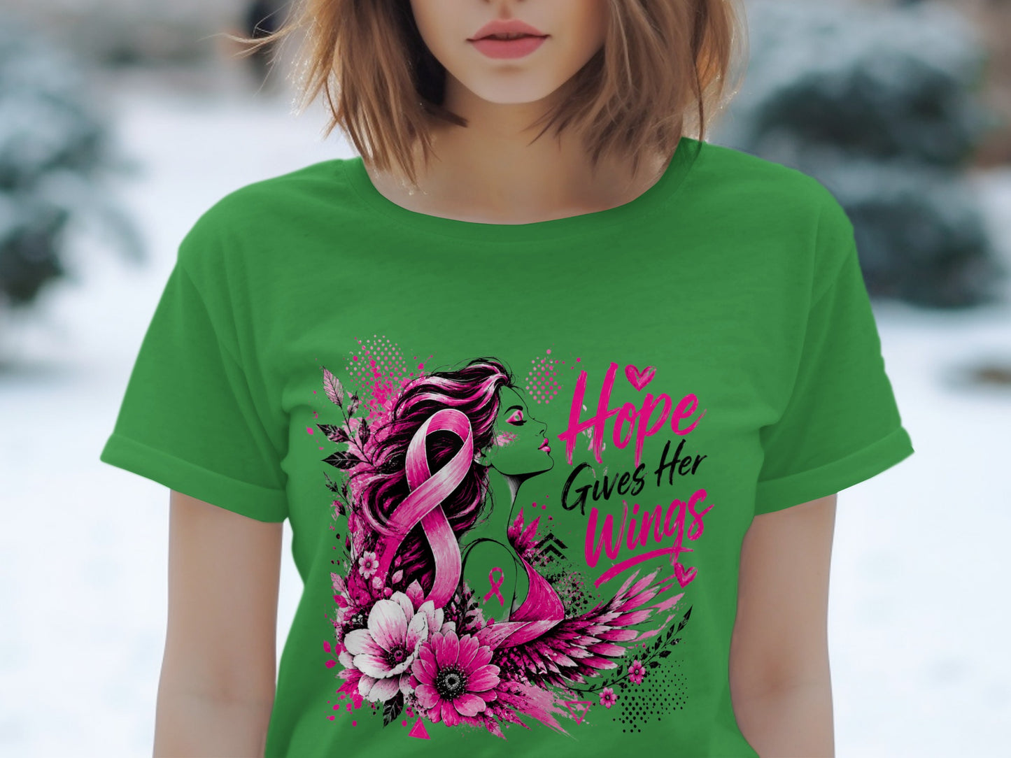Green t-shirt with pink breast cancer ribbon, floral design, and text "Hope Gives Her Wings".