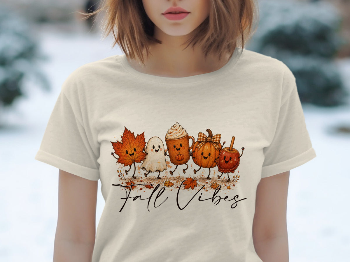 Cream t-shirt with a "Fall Vibes" graphic featuring animated autumn characters.