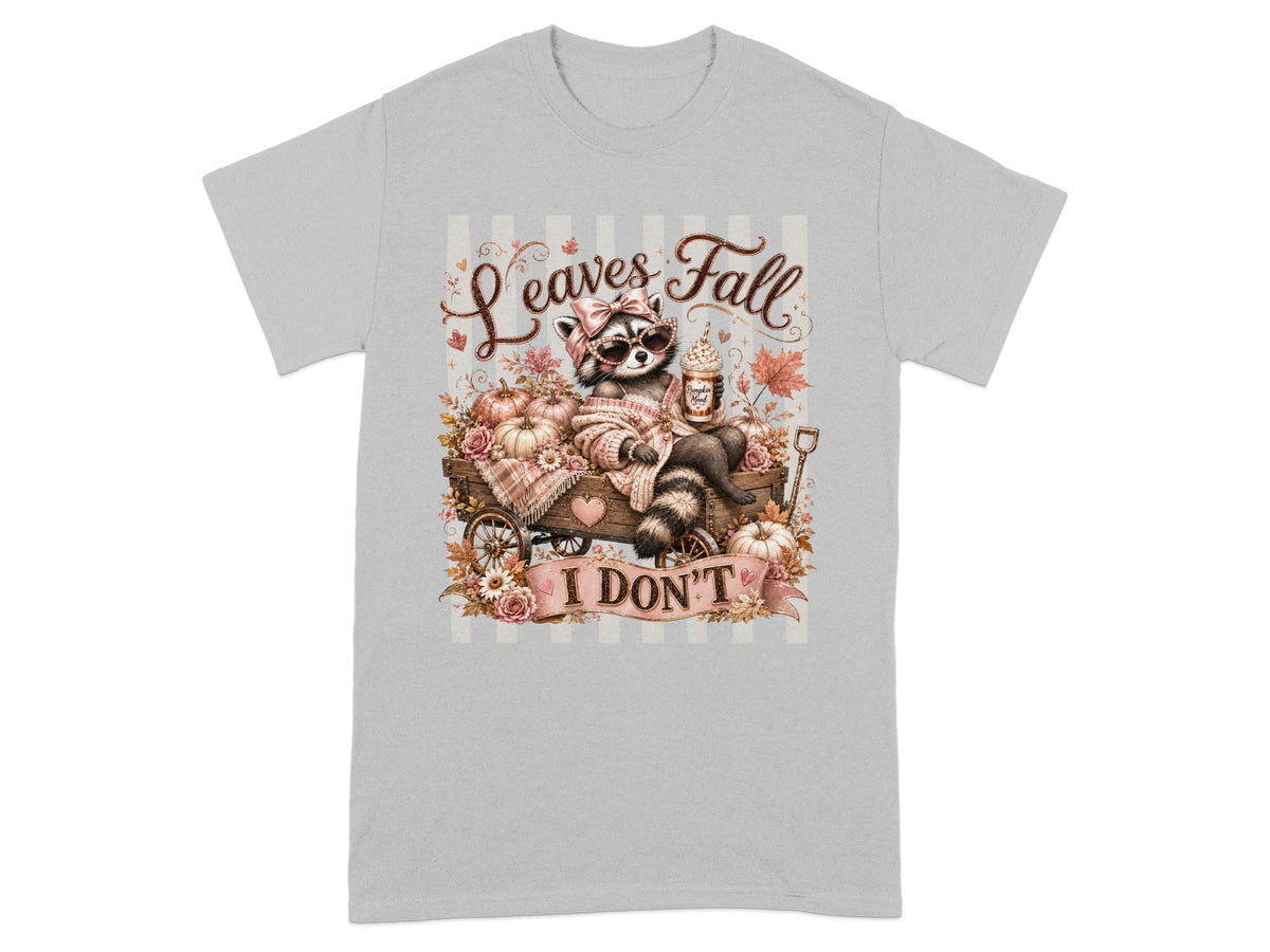 Raccoon with sunglasses and drink in a wagon with pumpkins and flowers, text "Leaves Fall I DON'T".