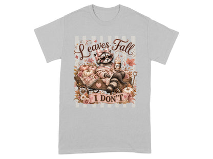 Raccoon with sunglasses and drink in a wagon with pumpkins and flowers, text "Leaves Fall I DON'T".