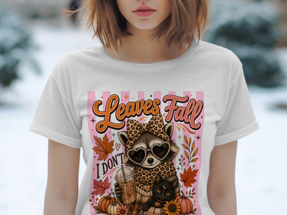Raccoon with heart sunglasses and cat on t-shirt with "Leaves Fall" text.