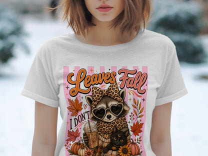 Raccoon with heart sunglasses and cat on t-shirt with "Leaves Fall" text.