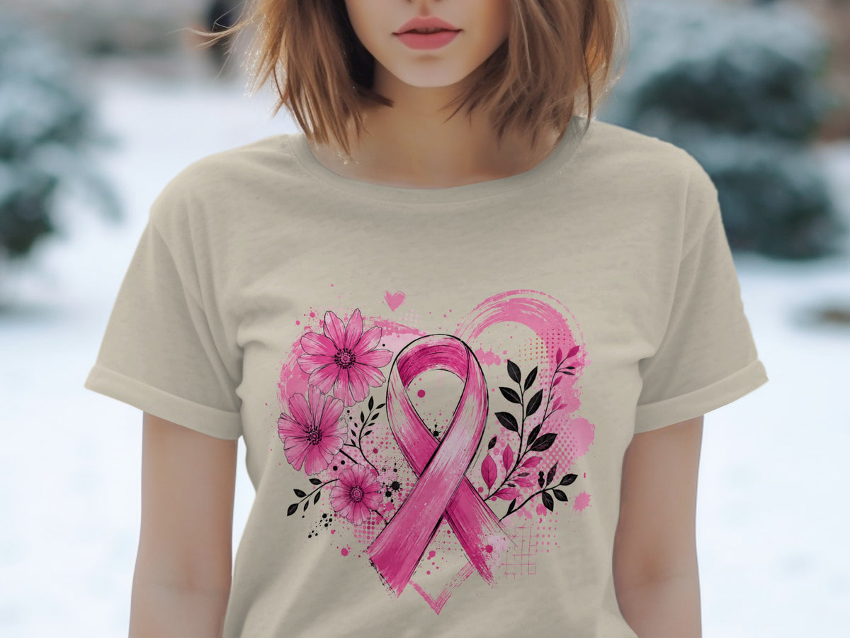 Pink ribbon with flowers and abstract heart design on tan t-shirt.