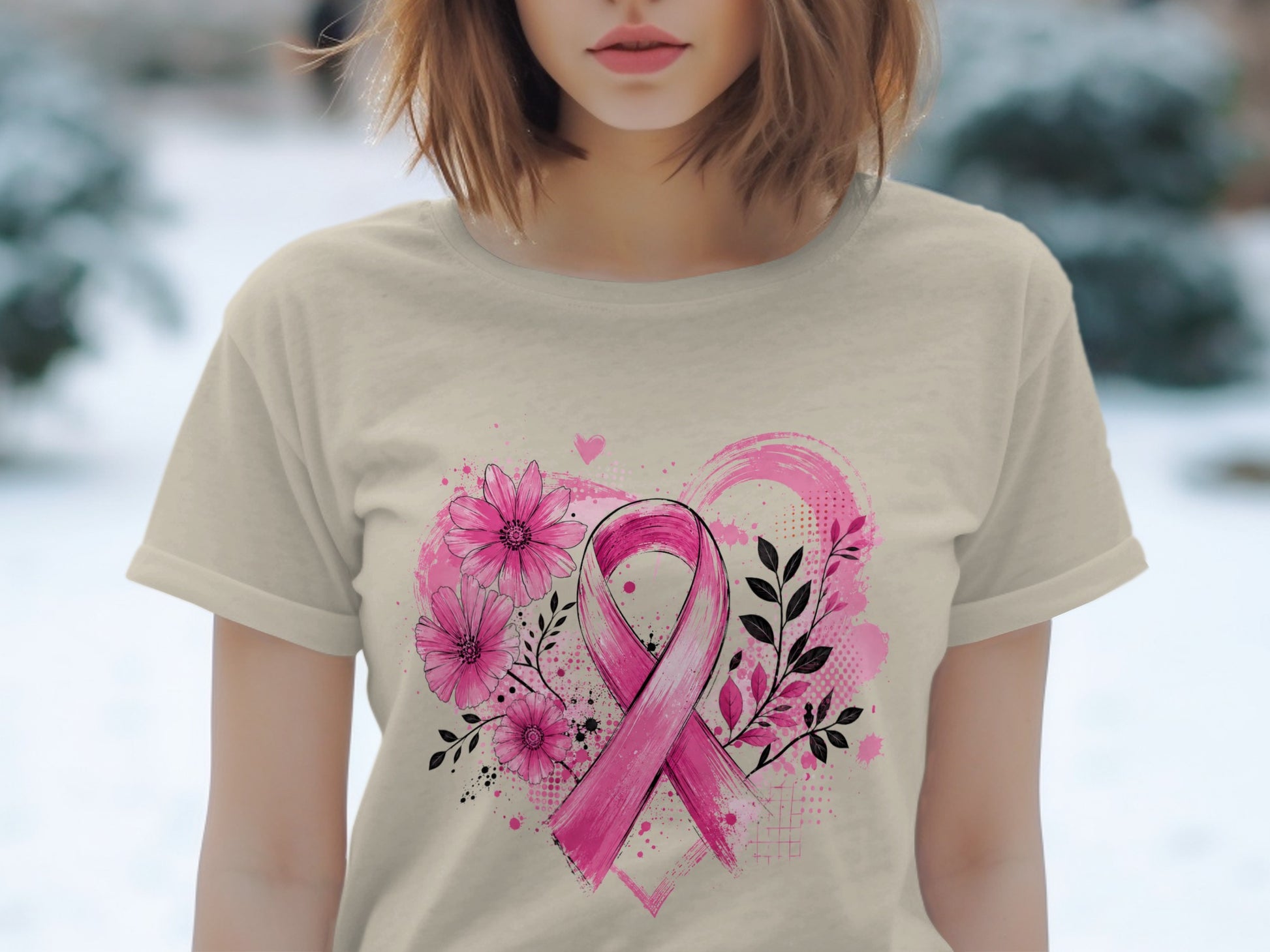 Pink ribbon with flowers and abstract heart design on tan t-shirt.