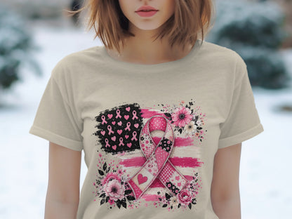 T-shirt graphic of a pink ribbon over a distressed American flag with flowers.