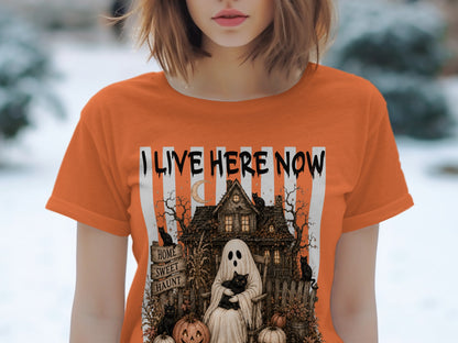 Orange t-shirt with "I LIVE HERE NOW" and haunted house, ghost, cats, and pumpkins graphic.