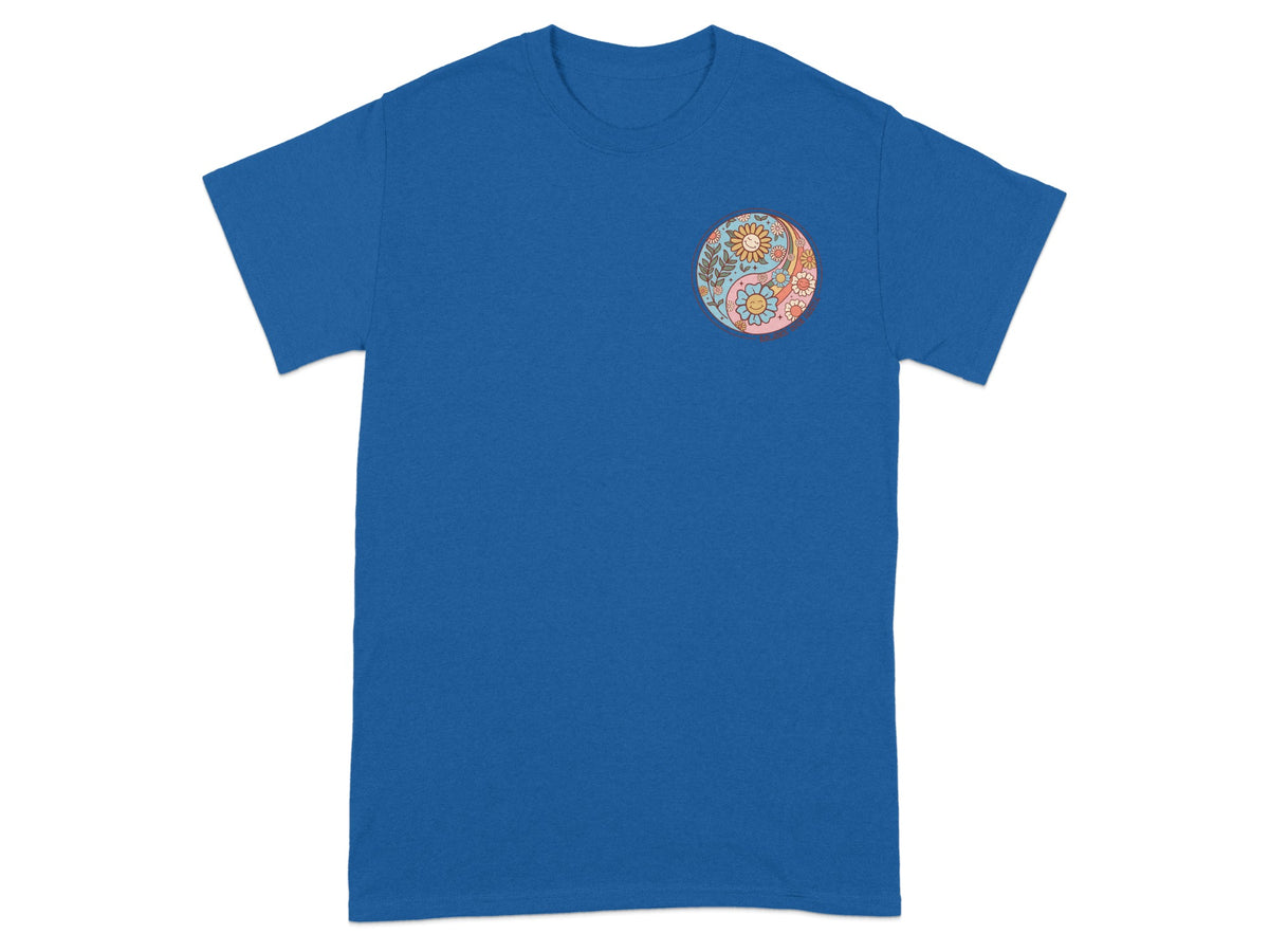 Blue t-shirt with a circular yin-yang design featuring flowers and smiling suns.