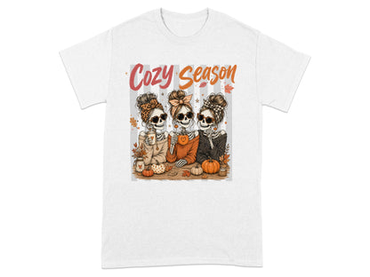 Three skeleton women with messy buns and sunglasses celebrate "Cozy Season" with pumpkins.