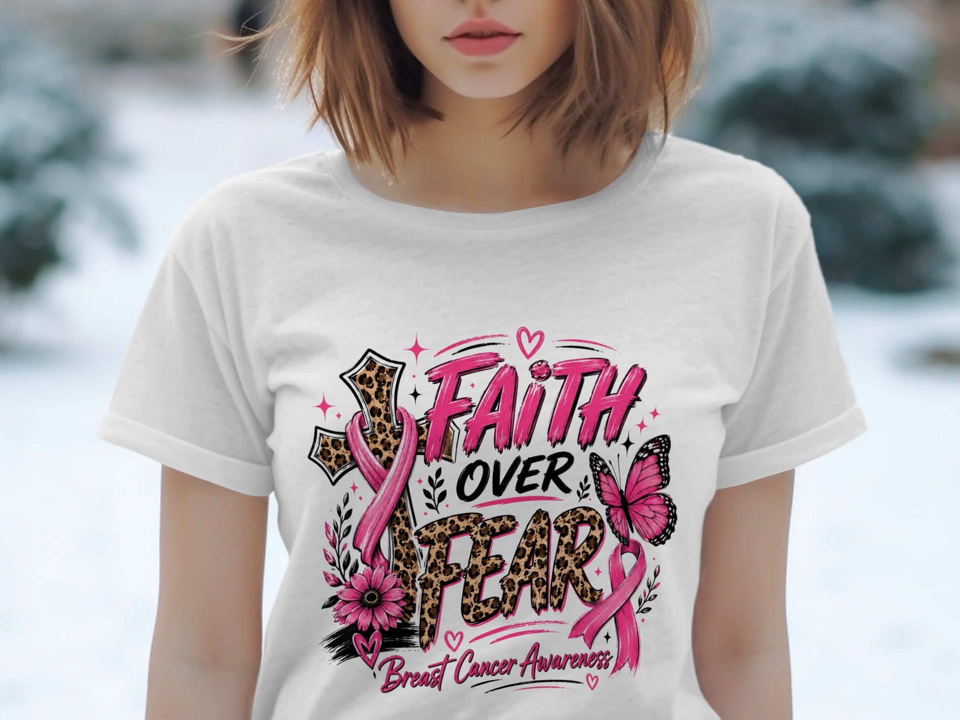 White t-shirt with "Faith Over Fear Breast Cancer Awareness" graphic featuring a cross, butterfly, and pink ribbons.