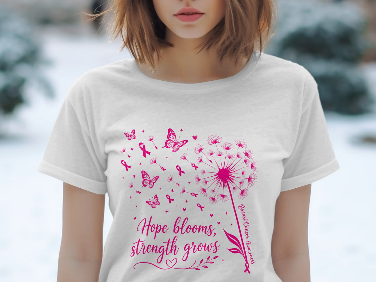 White t-shirt with pink dandelion graphic, butterflies, ribbons, and text.