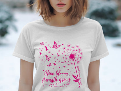 White t-shirt with pink dandelion graphic, butterflies, ribbons, and text.