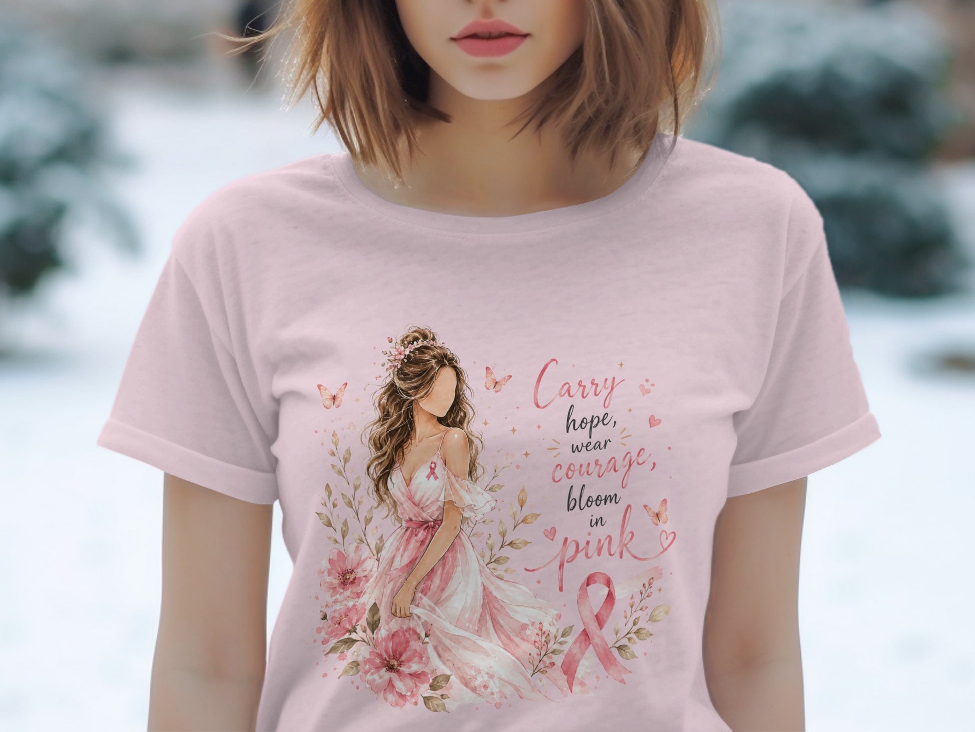 Pink t-shirt with watercolor art of woman, flowers, and "Carry hope, wear courage, bloom in pink" text.