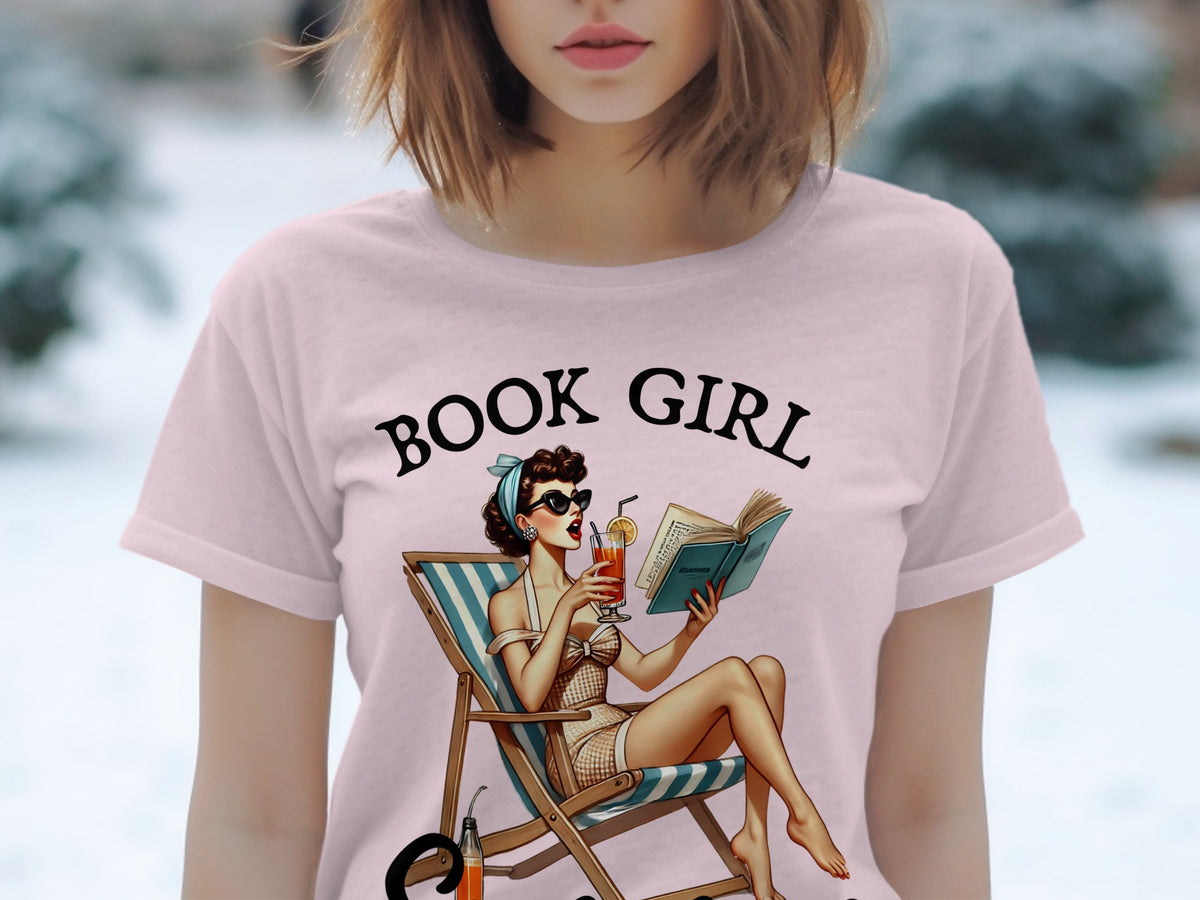 Pink t-shirt with "BOOK GIRL" text and vintage woman reading in lounge chair.