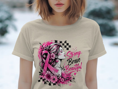 T-shirt graphic with woman, pink ribbon, flowers, and text: Strong Brave Beautiful.