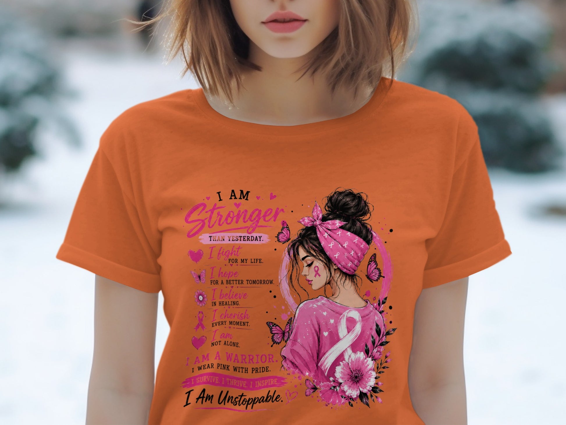 Orange t-shirt with breast cancer awareness graphic and empowering text.