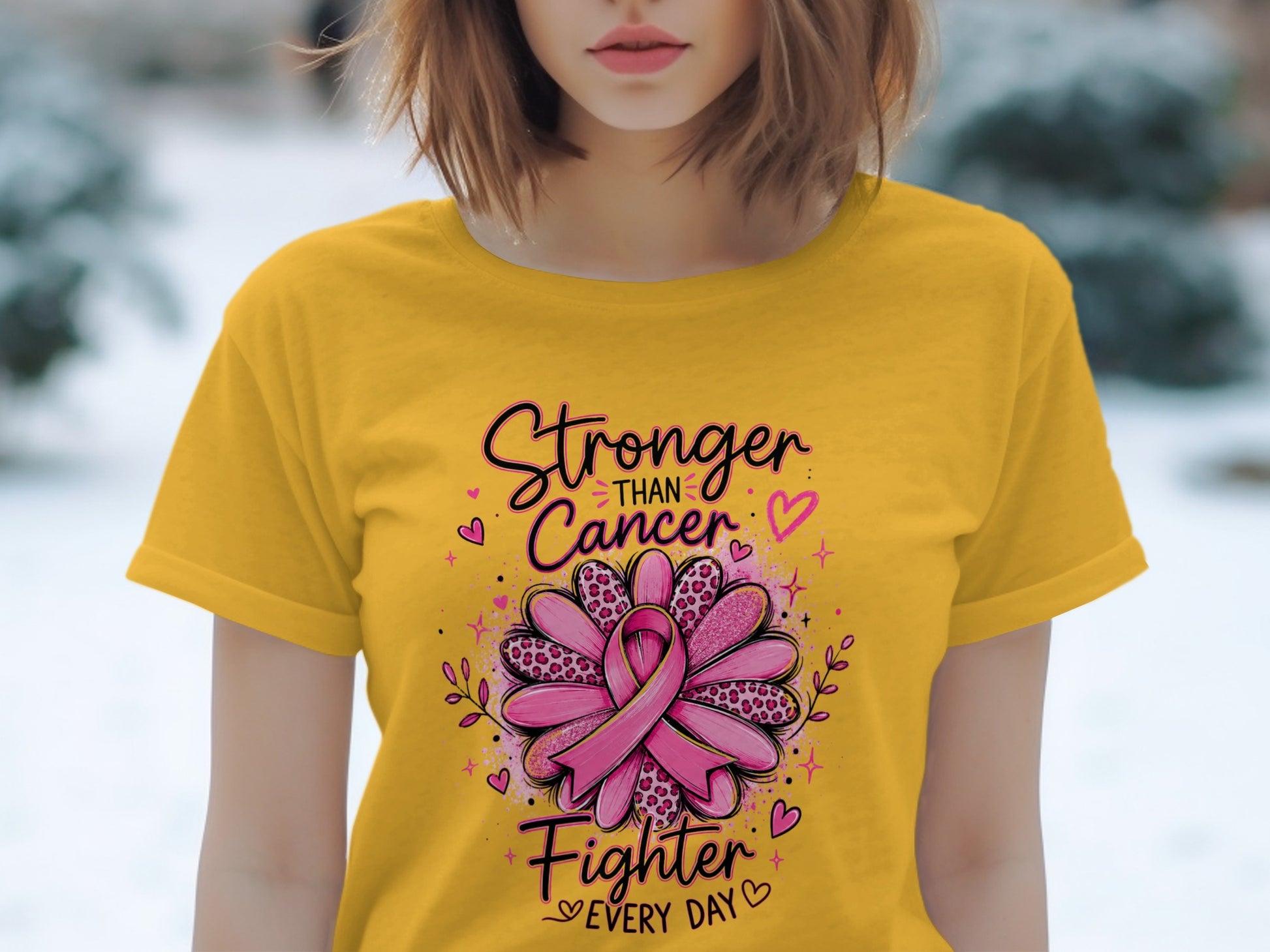 Yellow t-shirt with "Stronger Than Cancer Fighter Every Day" text and a pink ribbon.