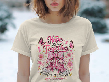T-shirt graphic with pink ribbon, sneakers, butterflies, and text "Hope Ties Us Together".