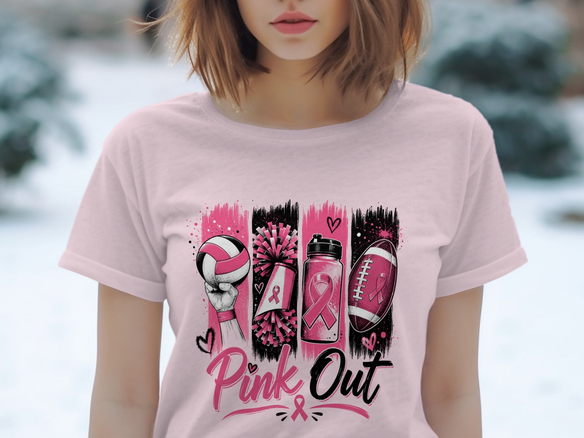 Pink Out graphic on a pink t-shirt featuring volleyball, pom-poms, water bottle, and football with ribbons.