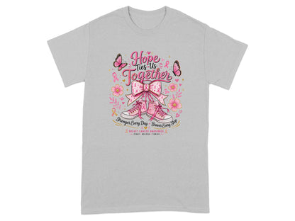 "Hope Ties Us Together" graphic on grey t-shirt with pink sneakers and breast cancer awareness ribbon design.