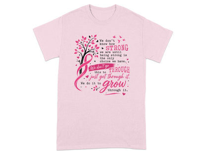 Pink t-shirt with a breast cancer ribbon and inspirational quote about strength and growth.