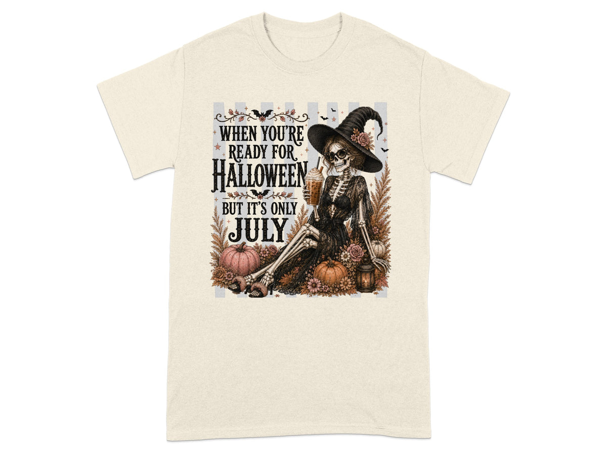 Skeleton witch with drink and pumpkins, text "When You're Ready for Halloween But It's Only July".