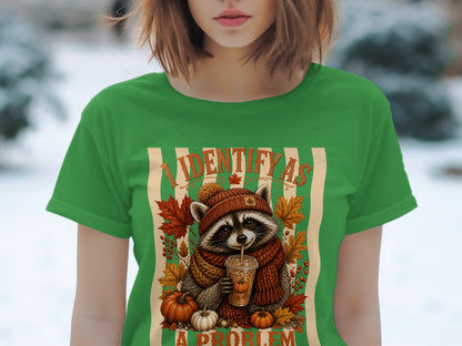 Raccoon in fall attire holding a drink, with text "I IDENTIFY AS A PROBLEM".