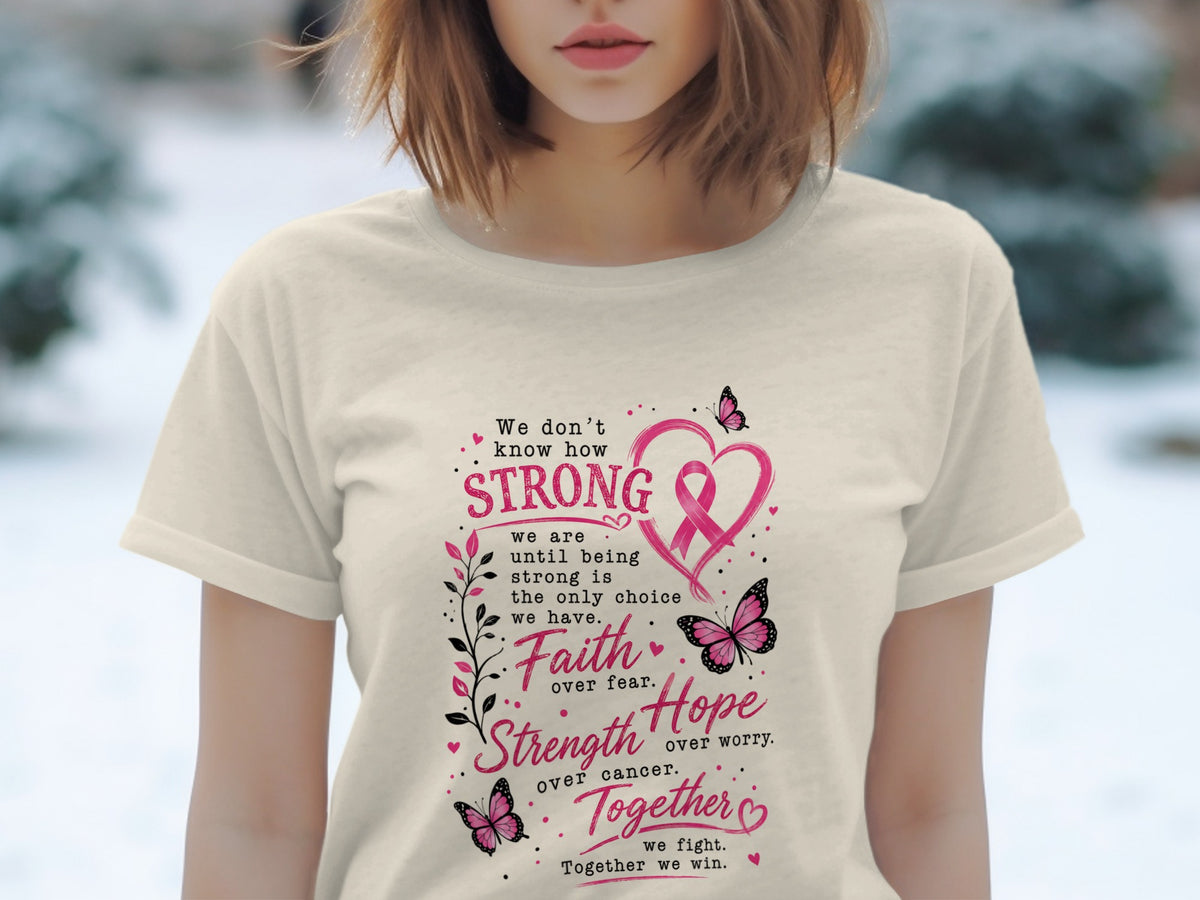 Cream t-shirt with pink text and graphics about strength, faith, hope, and fighting cancer.