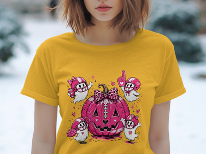 Yellow t-shirt featuring a pink football pumpkin with four football-themed ghosts.