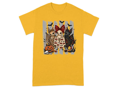 Three stylized Halloween-themed chihuahuas with bat wings and accessories on a t-shirt.