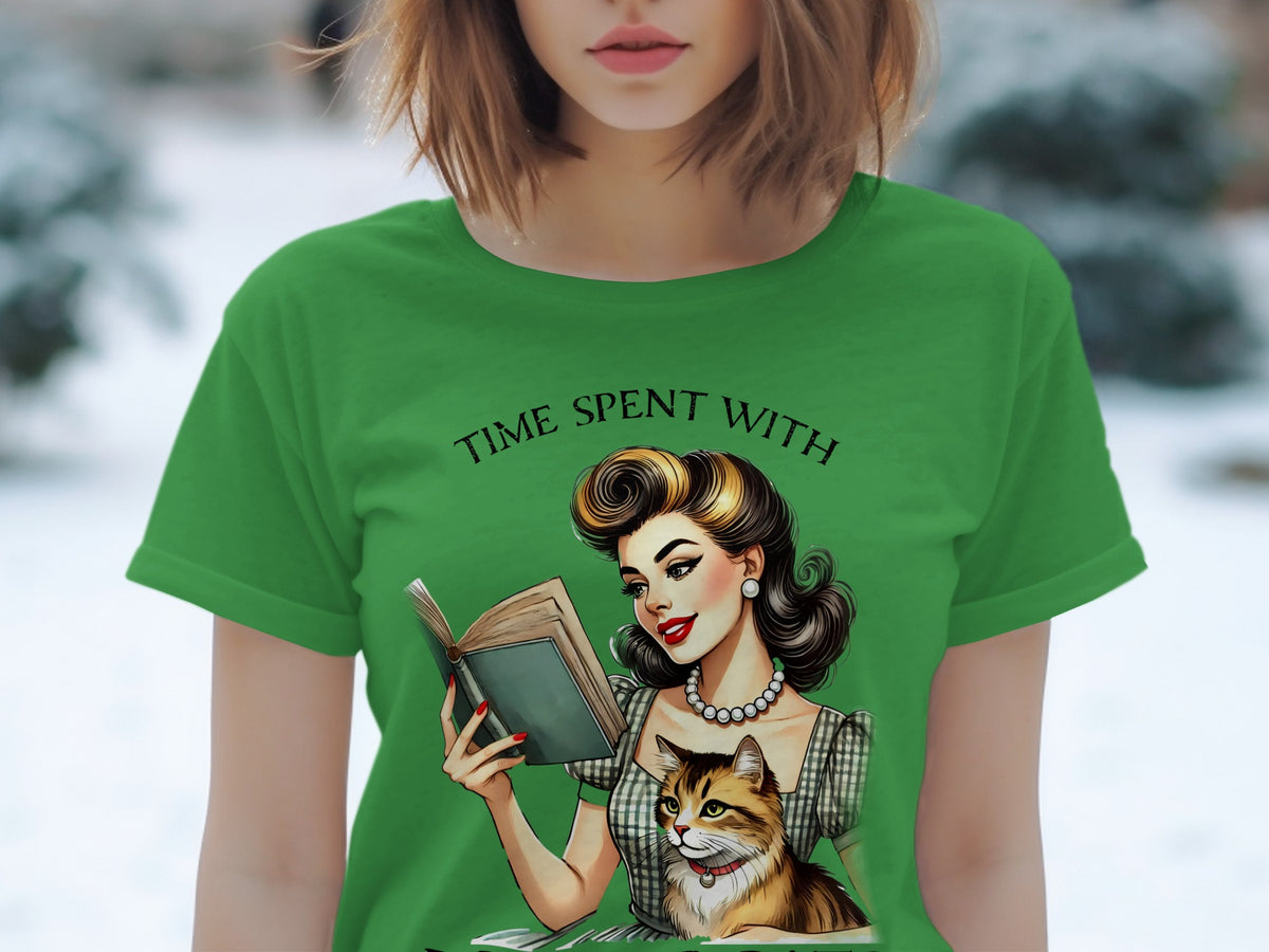 Green t-shirt with retro illustration of woman reading with cat, "Time Spent With" text.