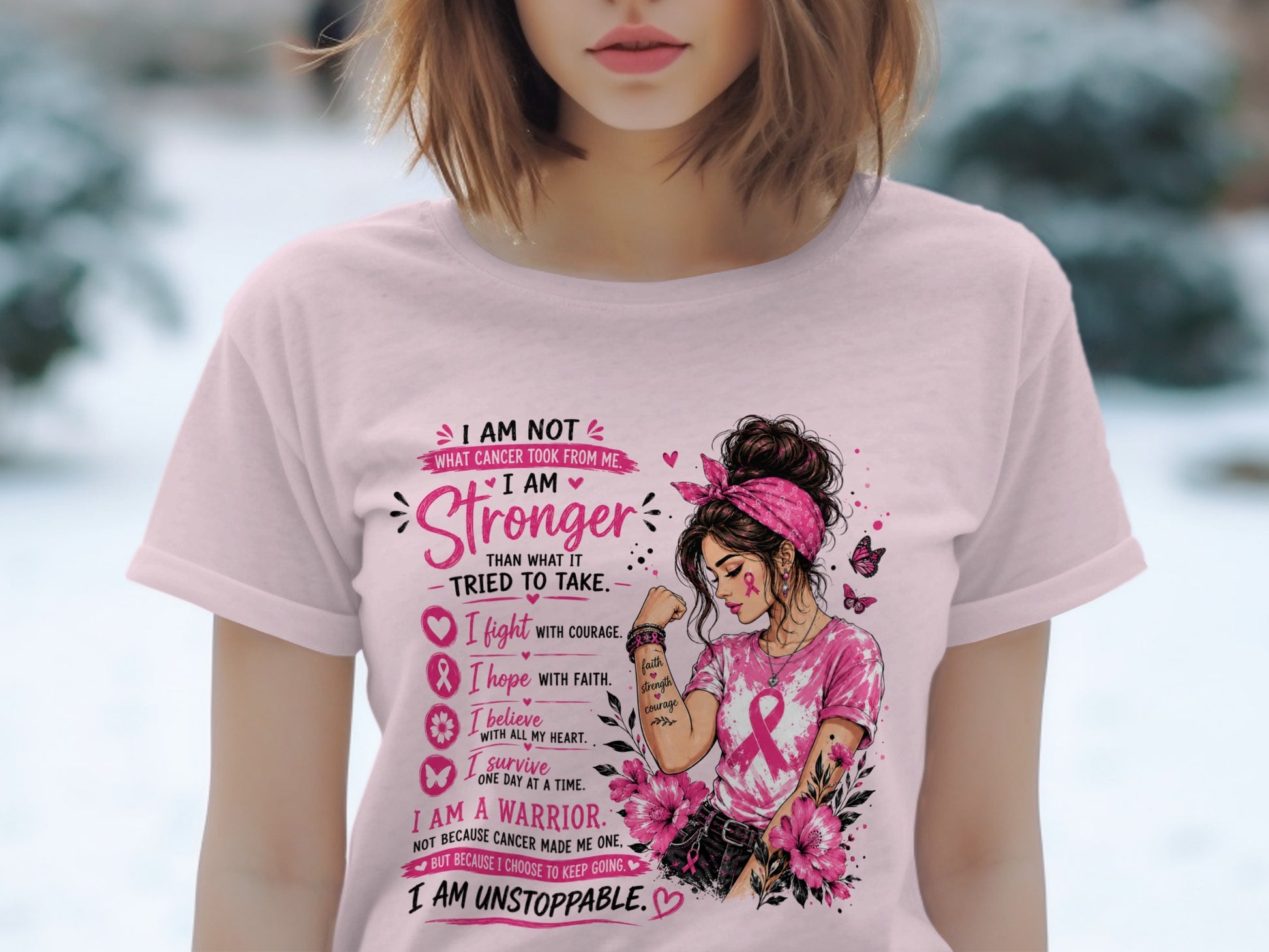 Pink t-shirt with "I Am Stronger Than What Cancer Took From Me" text and warrior graphic.