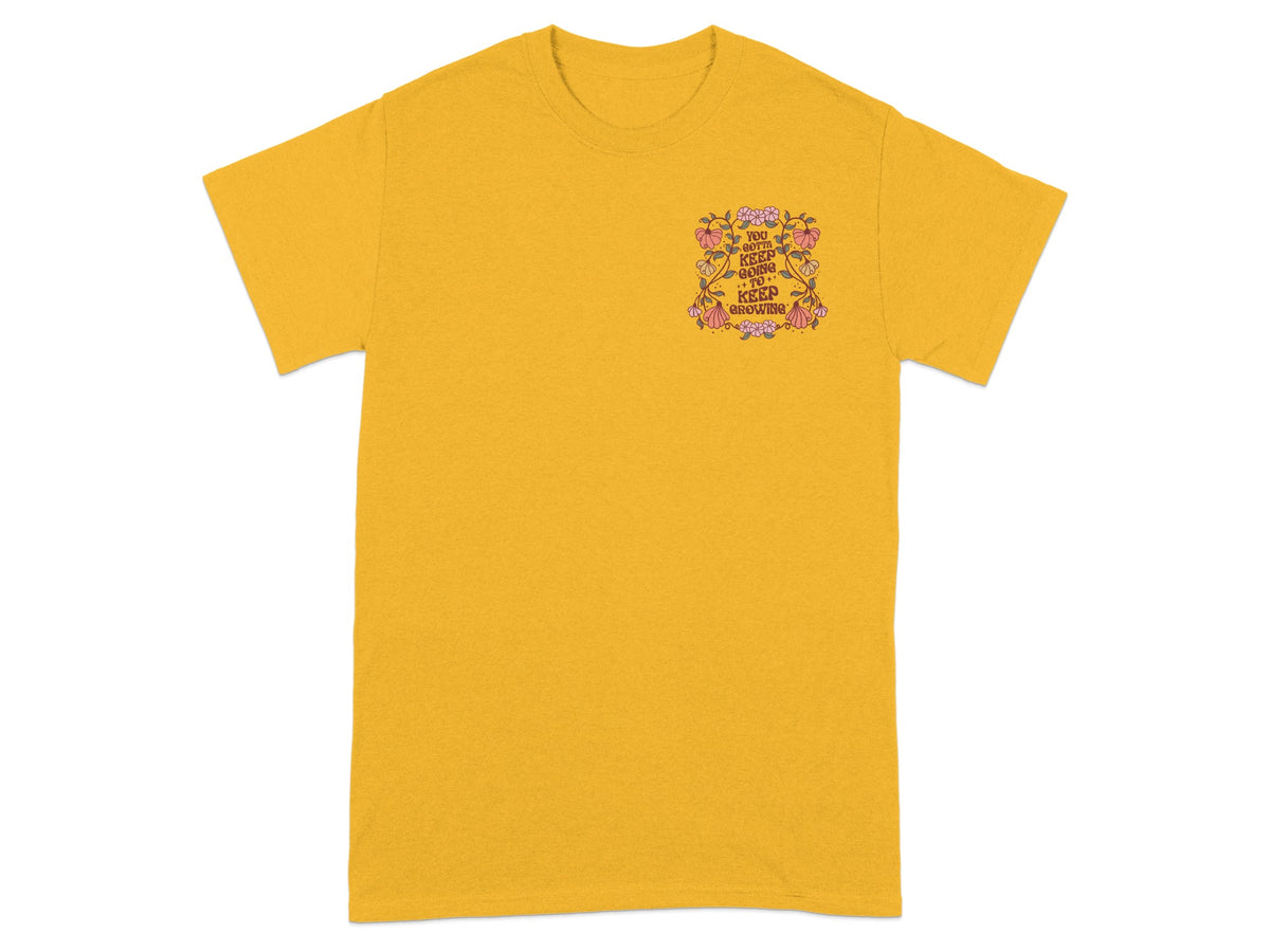 Yellow t-shirt with floral graphic and text "You Gotta Keep Going To Keep Growing".