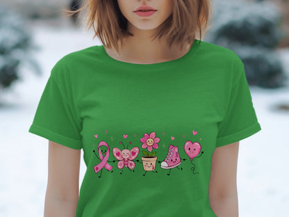 Green t-shirt with pink ribbon, butterfly, flower, shoe, and heart balloon cartoon characters.