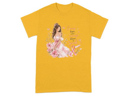Yellow t-shirt with woman, flowers, and text "Carry hope, wear courage, bloom in pink."