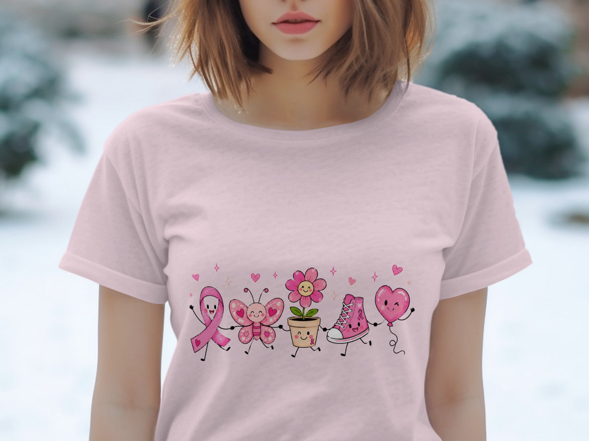 Pink t-shirt with a graphic of a pink ribbon, butterfly, flower, shoe, and heart balloon.