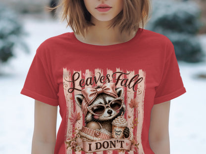Red t-shirt with a graphic of a raccoon in sunglasses holding a coffee drink, with text.