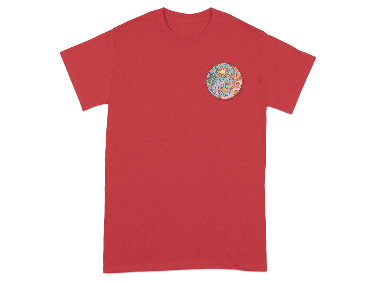 Red t-shirt with embroidered yin yang symbol featuring flowers and smiling suns.