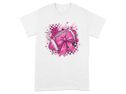 Pink football with ribbon, flowers, and checkered pattern on a white t-shirt.