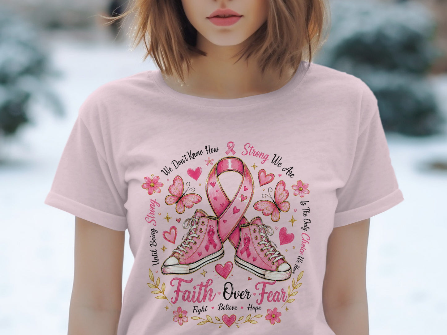 Pink t-shirt with "Faith Over Fear" graphic, pink ribbon, and sneakers.