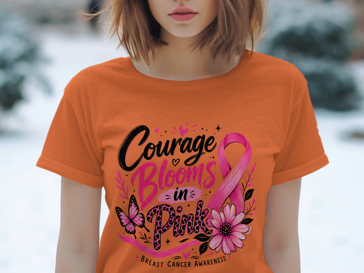 Orange t-shirt with "Courage Blooms in Pink" Breast Cancer Awareness graphic.