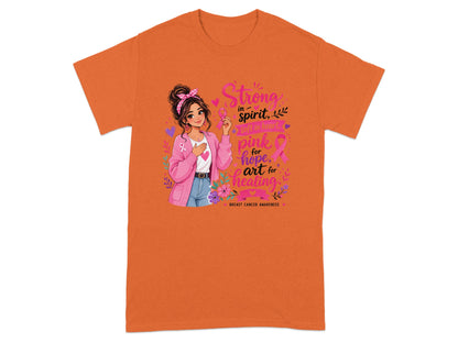 T-shirt graphic with a woman holding a pink ribbon and text "Strong in spirit, soft in heart, pink for hope, art for healing".