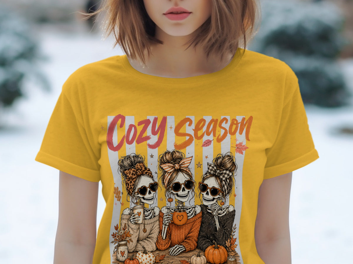 Yellow t-shirt with three skeleton figures and the text "Cozy Season."